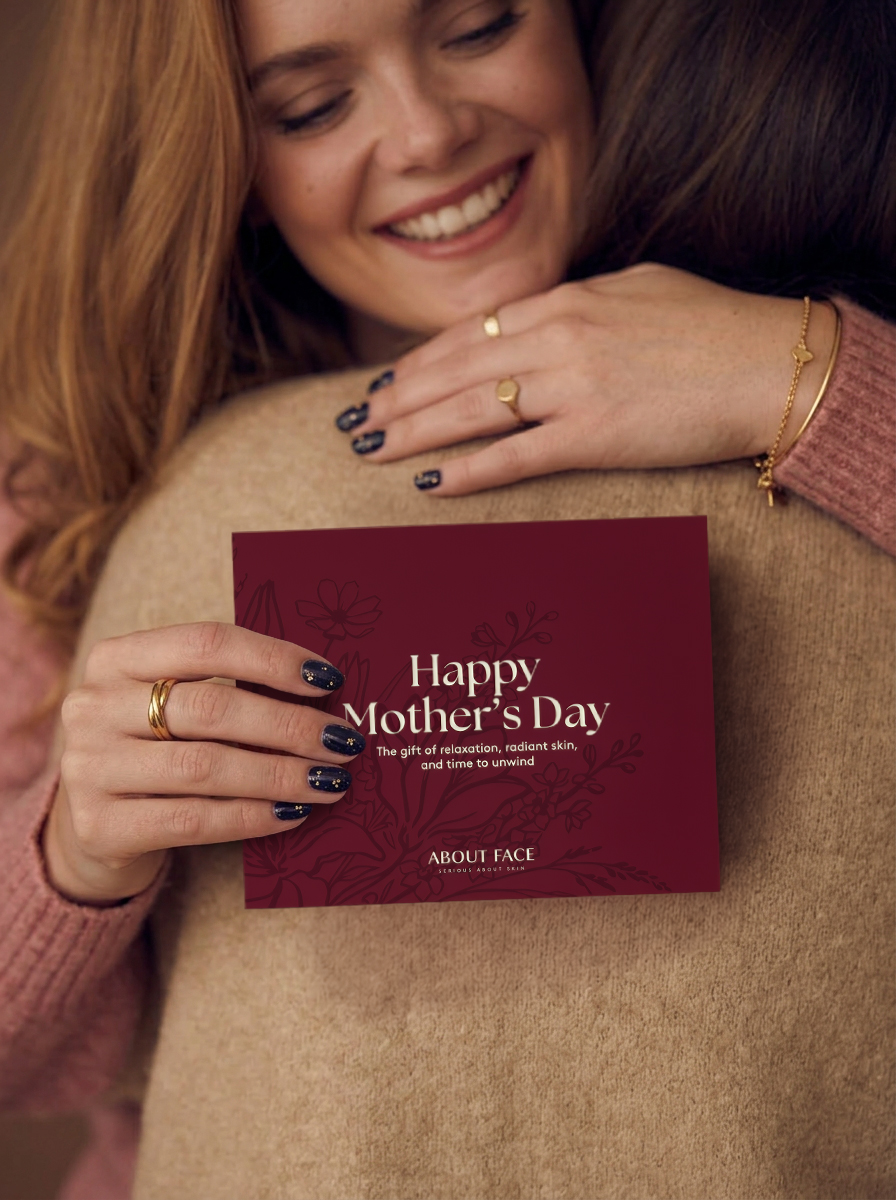 Woman holding an About Face Happy Mother’s Day card
