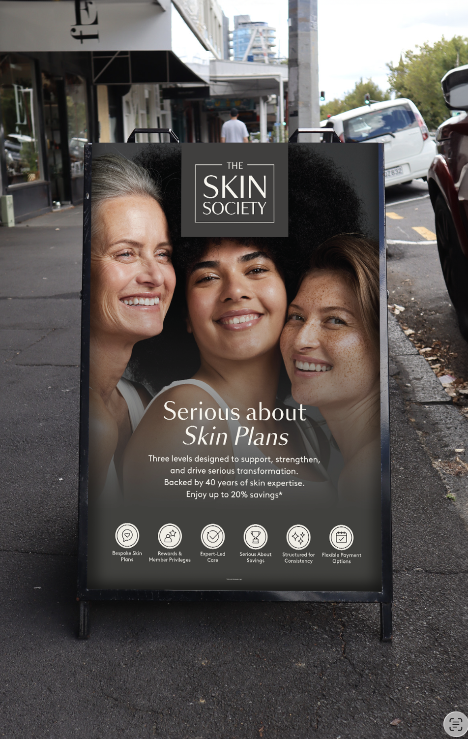 Skin Society campaign displayed on an outdoor pavement sign