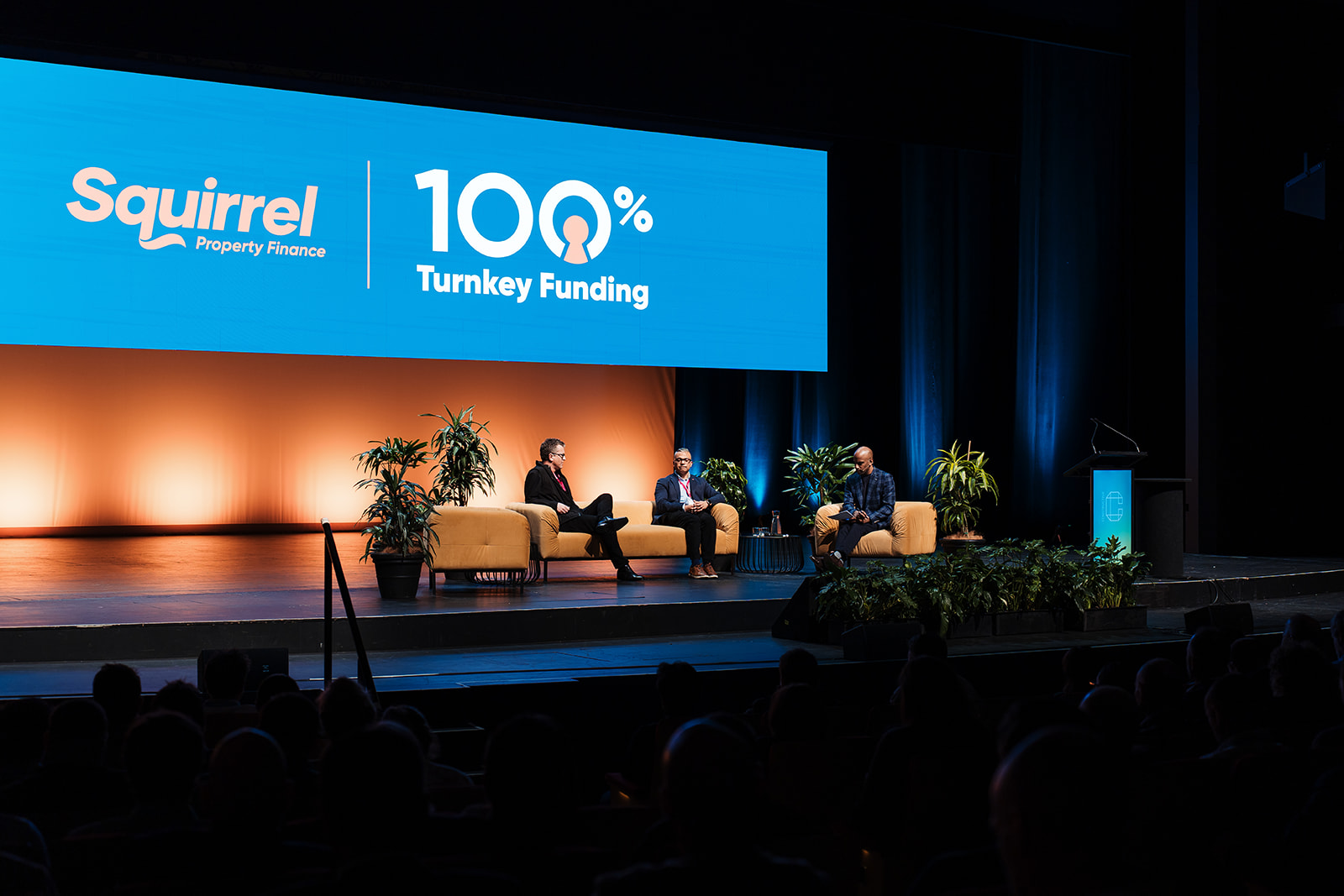 Squirrel 100% Turnkey Funding identity displayed on the Constructive Conference stage